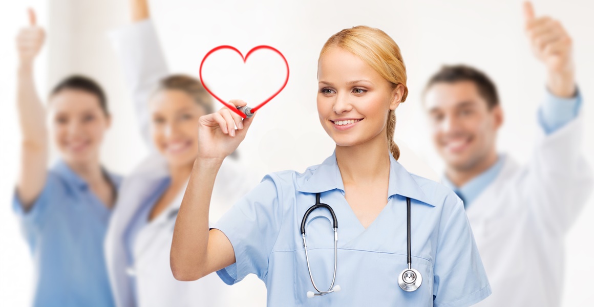 smiling doctor or nurse drawing red heart